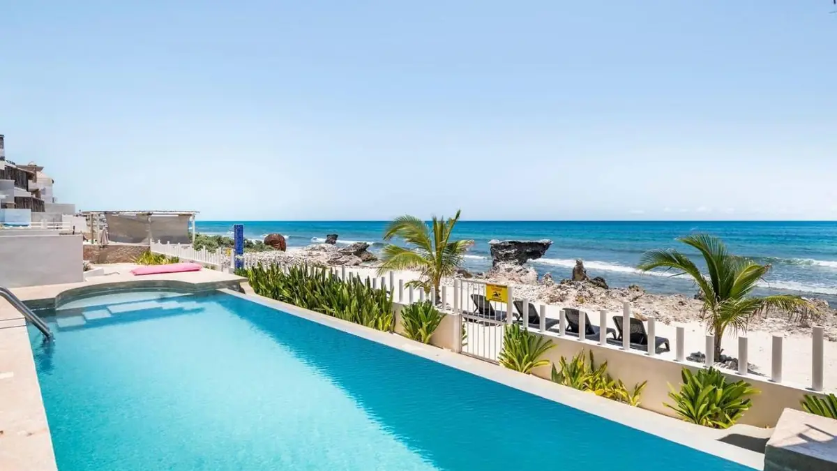 The infinity pool at Villas Najo' with the Caribbean Sea behind it